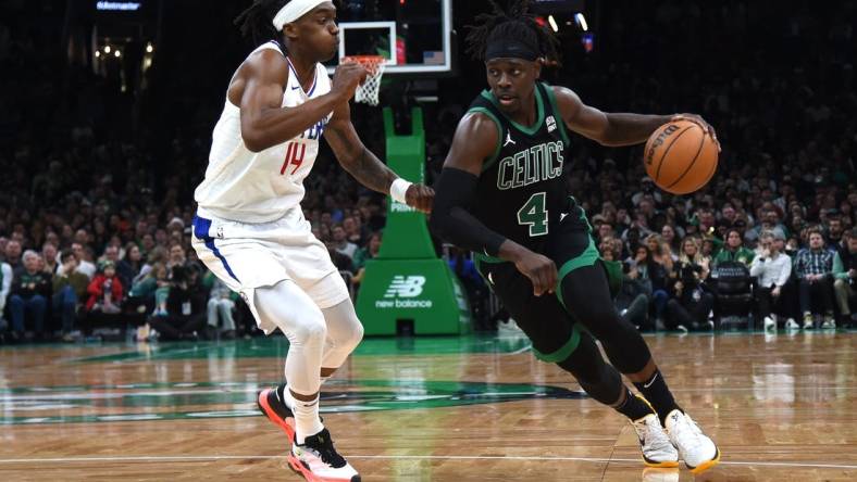 Jan 27, 2024; Boston, Massachusetts, USA;  Boston Celtics guard Jrue Holiday (4) controls the ball while LA Clippers guard Terance Mann (14) defends during the second half at TD Garden. Mandatory Credit: Bob DeChiara-USA TODAY Sports