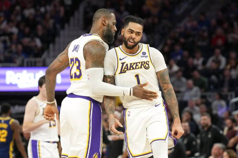 Jan 27, 2024; San Francisco, California, USA; Los Angeles Lakers forward LeBron James (23) celebrates with guard D'Angelo Russell (1) during the second overtime against the Golden State Warriors at Chase Center. Mandatory Credit: Darren Yamashita-USA TODAY Sports