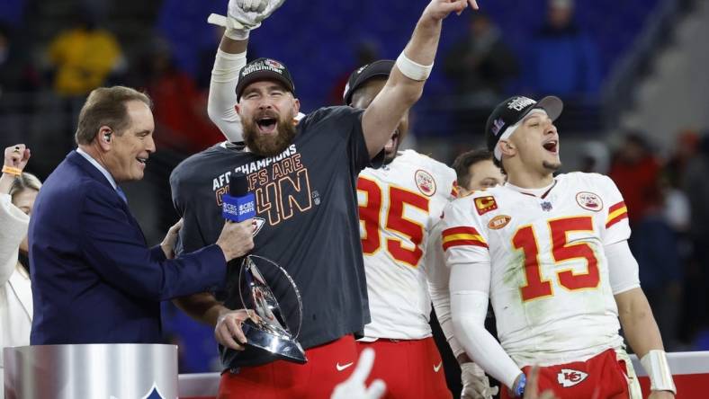 Jan 28, 2024; Baltimore, Maryland, USA; Kansas City Chiefs tight end Travis Kelce (M) celebrates with the Lamar Hunt Trophy while speaking with CBS broadcaster Jim Nance during the trophy presentation after the Chiefs' game against the Baltimore Ravens in the AFC Championship football game at M&T Bank Stadium. Mandatory Credit: Geoff Burke-USA TODAY Sports