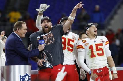 Jan 28, 2024; Baltimore, Maryland, USA; Kansas City Chiefs tight end Travis Kelce (M) celebrates with the Lamar Hunt Trophy while speaking with CBS broadcaster Jim Nance during the trophy presentation after the Chiefs' game against the Baltimore Ravens in the AFC Championship football game at M&T Bank Stadium. Mandatory Credit: Geoff Burke-USA TODAY Sports