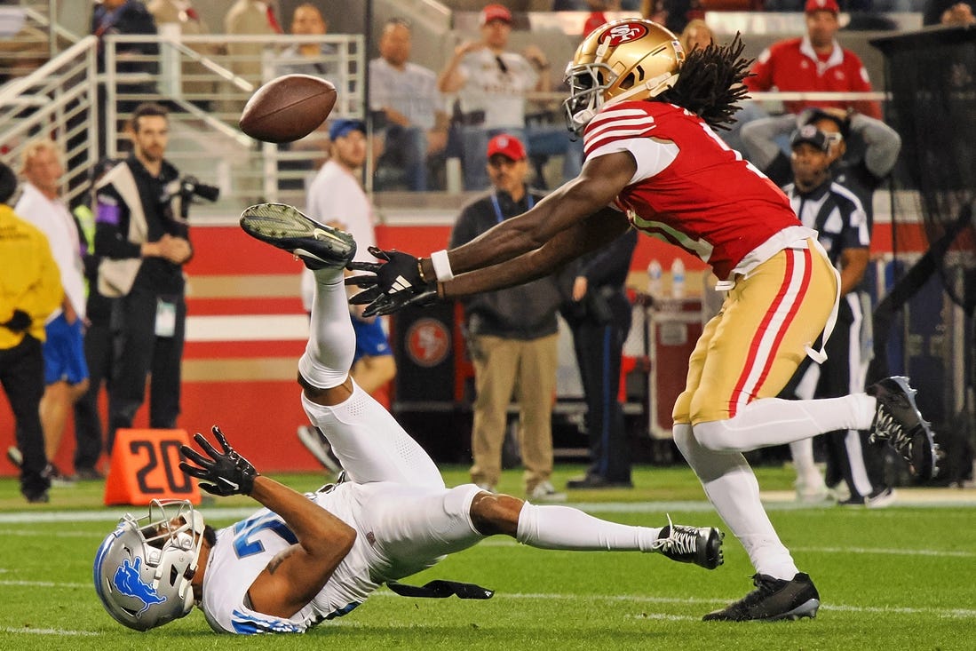 Jan 28, 2024; Santa Clara, California, USA; San Francisco 49ers wide receiver Brandon Aiyuk (11) reaches for a ball that bounced off the face mask of Detroit Lions cornerback Kindle Vildor (29) during the second half of the NFC Championship football game at Levi's Stadium. Mandatory Credit: Kelley L Cox-USA TODAY Sports