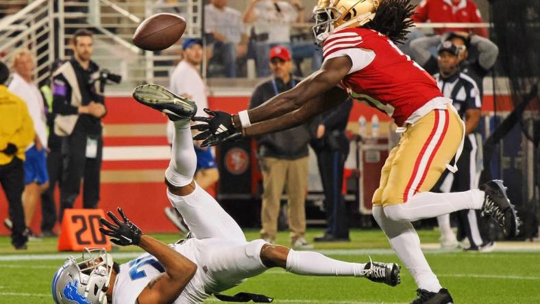 Jan 28, 2024; Santa Clara, California, USA; San Francisco 49ers wide receiver Brandon Aiyuk (11) reaches for a ball that bounced off the face mask of Detroit Lions cornerback Kindle Vildor (29) during the second half of the NFC Championship football game at Levi's Stadium. Mandatory Credit: Kelley L Cox-USA TODAY Sports