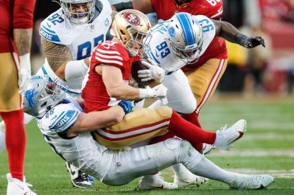 Lions linebacker Jack Campbell tackles 49ers running back Christian McCaffrey during the first half of the NFC championship game at Levi's Stadium in Santa Clara, California, on Sunday, Jan. 28, 2024.