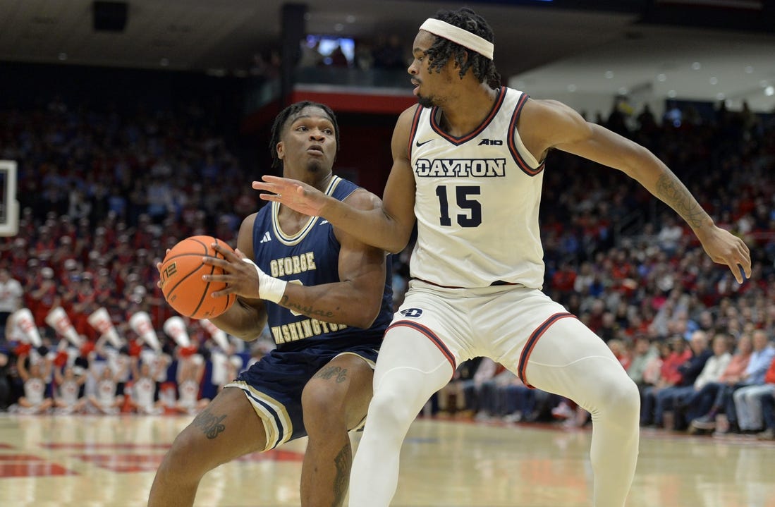 Jan 30, 2024; Dayton, Ohio, USA;  George Washington forward Darren Buchanan Jr. (3) drives against Dayton Flyers forward DaRon Holmes II (15) at University of Dayton Arena. Mandatory Credit: Matt Lunsford-USA TODAY Sports