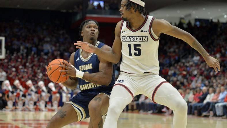 Jan 30, 2024; Dayton, Ohio, USA;  George Washington forward Darren Buchanan Jr. (3) drives against Dayton Flyers forward DaRon Holmes II (15) at University of Dayton Arena. Mandatory Credit: Matt Lunsford-USA TODAY Sports