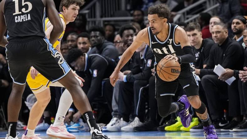 Jan 30, 2024; Atlanta, Georgia, USA; Atlanta Hawks guard Trae Young (11) dribbles against the Los Angeles Lakers during the first half at State Farm Arena. Mandatory Credit: Dale Zanine-USA TODAY Sports