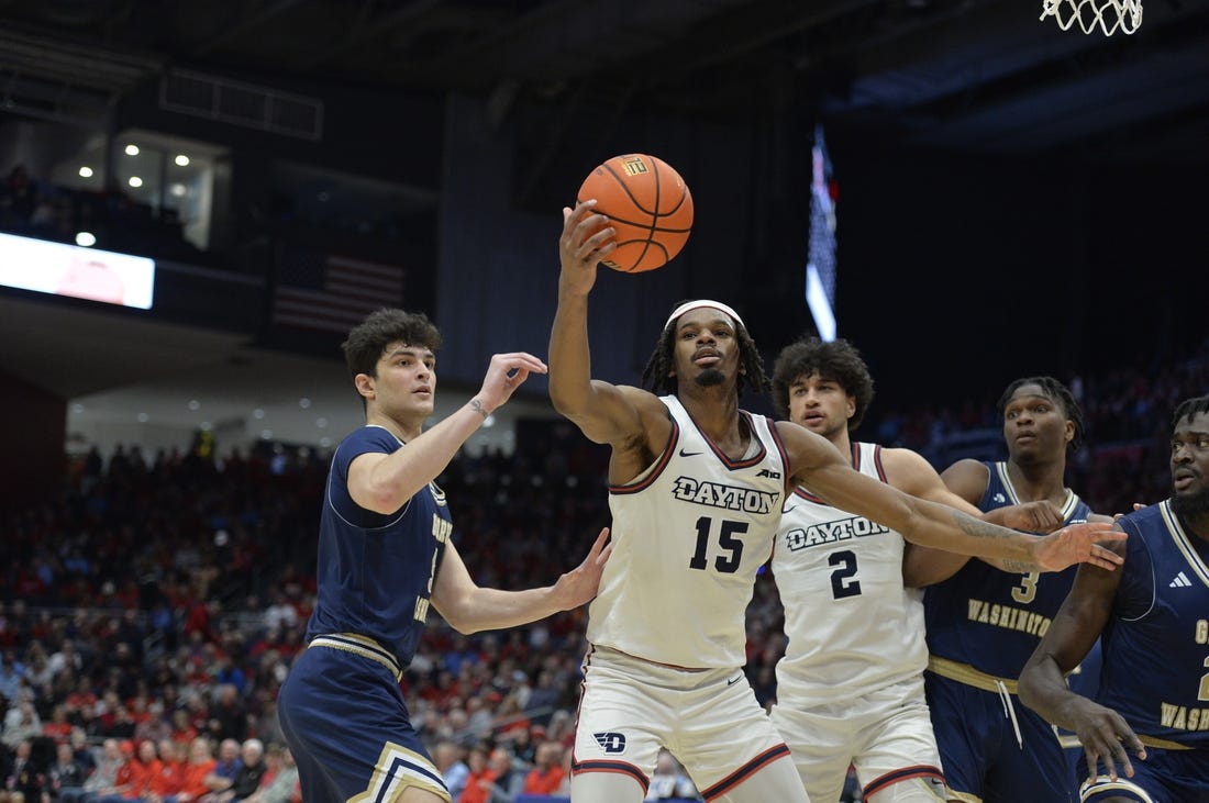 Jan 30, 2024; Dayton, Ohio, USA;  Dayton Flyers forward DaRon Holmes II (15) grabs a rebound against George Washington guard Garrett Johnson (9) during the game at University of Dayton Arena. Mandatory Credit: Matt Lunsford-USA TODAY Sports