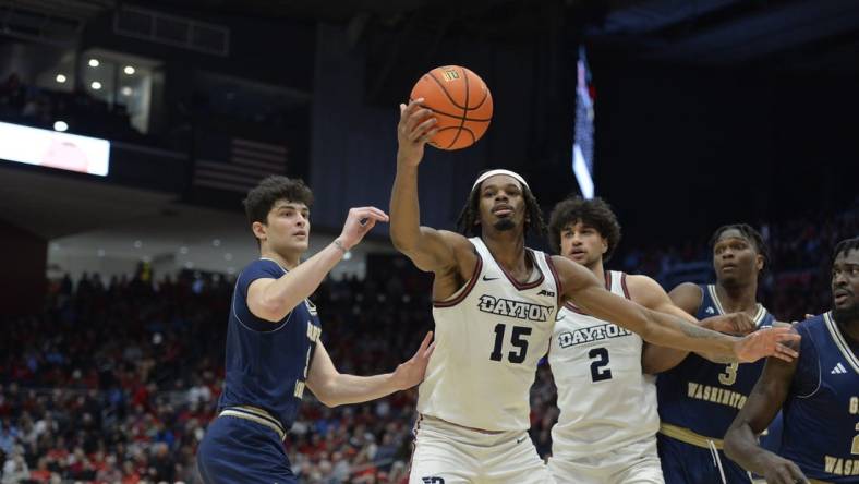 Jan 30, 2024; Dayton, Ohio, USA;  Dayton Flyers forward DaRon Holmes II (15) grabs a rebound against George Washington guard Garrett Johnson (9) during the game at University of Dayton Arena. Mandatory Credit: Matt Lunsford-USA TODAY Sports