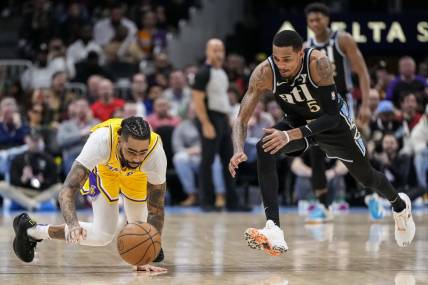 Jan 30, 2024; Atlanta, Georgia, USA; Los Angeles Lakers guard D'Angelo Russell (1) loses and dives for the ball next to Atlanta Hawks guard Dejounte Murray (5) during the second half at State Farm Arena. Mandatory Credit: Dale Zanine-USA TODAY Sports