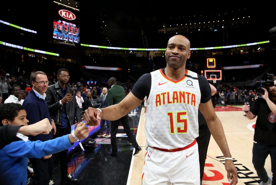 Mar 11, 2020; Atlanta, Georgia, USA; Atlanta Hawks guard Vince Carter (15) fist bumps fans after an overtime loss to the New York Knicks at State Farm Arena. Mandatory Credit: Jason Getz-USA TODAY Sports