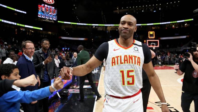 Mar 11, 2020; Atlanta, Georgia, USA; Atlanta Hawks guard Vince Carter (15) fist bumps fans after an overtime loss to the New York Knicks at State Farm Arena. Mandatory Credit: Jason Getz-USA TODAY Sports