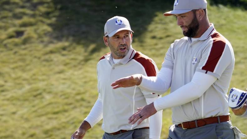 Sep 25, 2021; Haven, Wisconsin, USA; Team Europe player Sergio Garcia talks with Team Europe player Jon Rahm after a missed putt on the sixth green during day two four-ball rounds for the 43rd Ryder Cup golf competition at Whistling Straits. Mandatory Credit: Michael Madrid-USA TODAY Sports