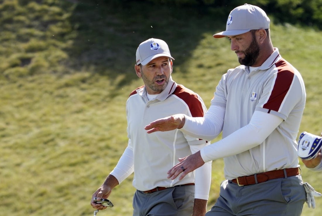 Sep 25, 2021; Haven, Wisconsin, USA; Team Europe player Sergio Garcia talks with Team Europe player Jon Rahm after a missed putt on the sixth green during day two four-ball rounds for the 43rd Ryder Cup golf competition at Whistling Straits. Mandatory Credit: Michael Madrid-USA TODAY Sports