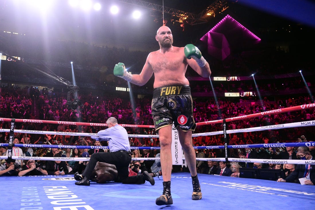 Oct 9, 2021; Las Vegas, Nevada, USA; Deontay Wilder (red/black trunks) is knocked out by Tyson Fury (black/gold trunks) during their WBC/Lineal heavyweight championship boxing match at T-Mobile Arena. Mandatory Credit: Joe Camporeale-USA TODAY Sports