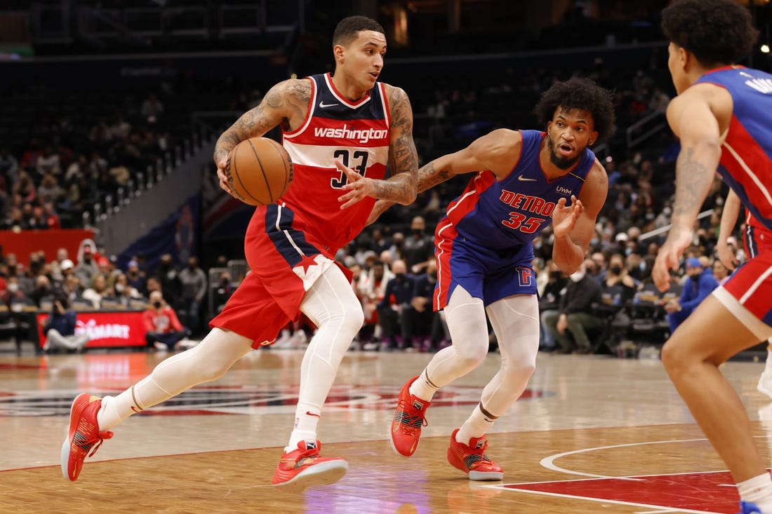 Feb 14, 2022; Washington, District of Columbia, USA; Washington Wizards forward Kyle Kuzma (33) drives to the basket past Detroit Pistons forward Marvin Bagley III (35) in the fourth quarter at Capital One Arena. Mandatory Credit: Geoff Burke-USA TODAY Sports