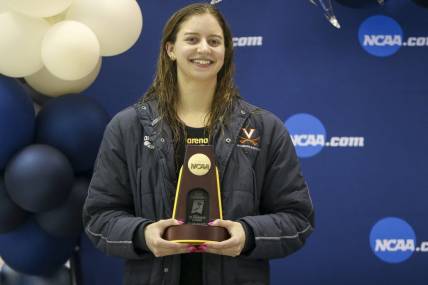 Mar 18, 2022; Atlanta, Georgia, USA; Virginia Cavaliers swimmer Kate Douglass holds a trophy after winning the 400 IM at the NCAA Swimming & Diving Championships at Georgia Tech. Mandatory Credit: Brett Davis-USA TODAY Sports