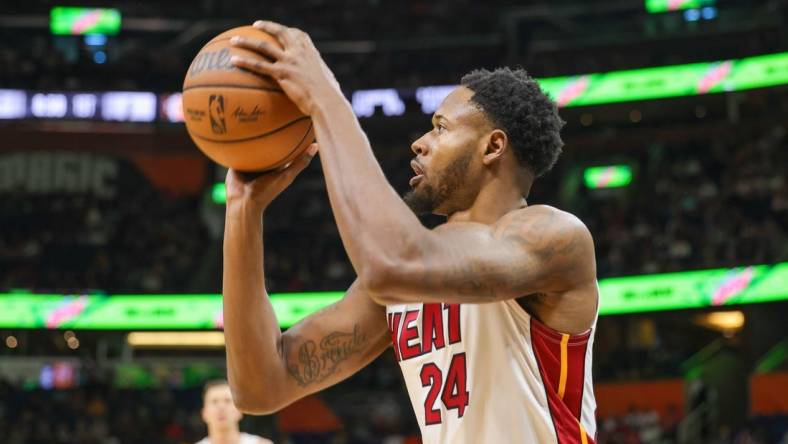 Apr 10, 2022; Orlando, Florida, USA; Miami Heat forward Haywood Highsmith (24) shoots a three-point basket against the Orlando Magic during the first quarter at Amway Center. Mandatory Credit: Mike Watters-USA TODAY Sports