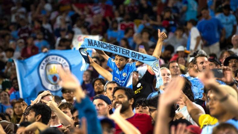 A young fan holds a "Manchester City" scarf after the exhibition match between FC Bayern Munich and Manchester City on Saturday, July 23, 2022, at Lambeau Field in Green Bay, Wis.

Gpg Bayern Man City Match 7232022 0004