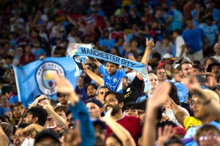 A young fan holds a "Manchester City" scarf after the exhibition match between FC Bayern Munich and Manchester City on Saturday, July 23, 2022, at Lambeau Field in Green Bay, Wis.

Gpg Bayern Man City Match 7232022 0004