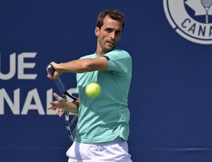 Aug 11, 2022; Montreal, QC, Canada; Albert Ramos-Vinolas (ESP) hits a forehand against against Hubert Hurkacz (POL) (not pictured) in third round play in the National Bank Open at IGA Stadium. Mandatory Credit: Eric Bolte-USA TODAY Sports