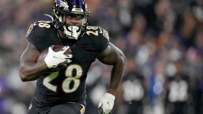 Baltimore Ravens running back Mike Davis (28) carries the ball in the second quarter during an NFL Week 5 game against the Cincinnati Bengals, Sunday, Oct. 9, 2022, at M&T Bank Stadium in Baltimore.

Nfl Cincinnati Bengals At Baltimore Ravens Oct 9 0176