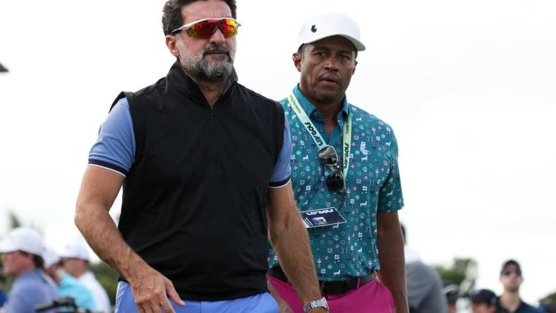 Oct 29, 2022; Miami, Florida, USA; Yasir Al-Rumayyan (L) walks next to Saudi golf CEO Majed Al Surour (R) during the second round of the season finale of the LIV Golf series at Trump National Doral. Mandatory Credit: Jasen Vinlove-USA TODAY Sports