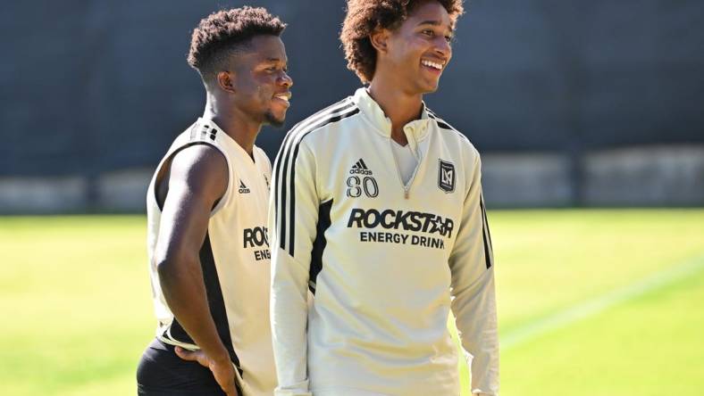 Nov 2, 2022; Los Angeles, California, US;  LAFC forward Kwadwo Opokug (22) and defender Julian Gaines (80) laugh during practice at the Nectar Performance Center.  Mandatory Credit: Jayne Kamin-Oncea-USA TODAY Sports