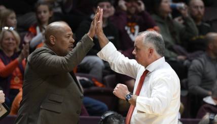 Nov 28, 2022; Blacksburg, Virginia, USA; Virginia Tech Hokies head coach Mike Young (right) high fives his assistant coach Mike Jones during the second half against the Minnesota Golden Gophers at Cassell Coliseum. Mandatory Credit: Lee Luther Jr.-USA TODAY Sports