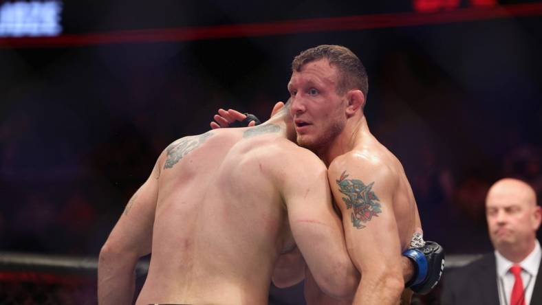 Dec 3, 2022; Orlando, Florida, USA; Jack Hermansson (red gloves) hugs Roman Dolidze (blue gloves) after the fight during UFC Fight Night at Amway Center. Mandatory Credit: Nathan Ray Seebeck-USA TODAY Sports