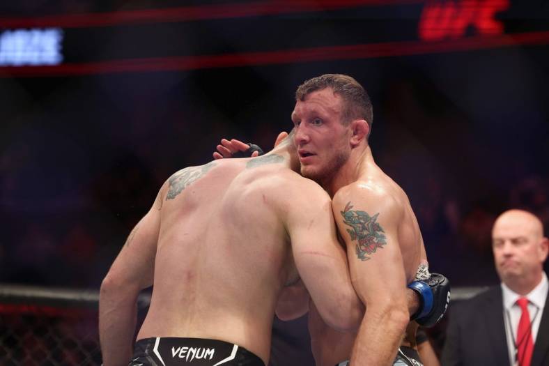 Dec 3, 2022; Orlando, Florida, USA; Jack Hermansson (red gloves) hugs Roman Dolidze (blue gloves) after the fight during UFC Fight Night at Amway Center. Mandatory Credit: Nathan Ray Seebeck-USA TODAY Sports