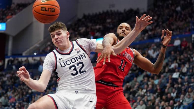 Jan 15, 2023; Hartford, Connecticut, USA; UConn Huskies center Donovan Clingan (32) and St. John's Red Storm center Joel Soriano (11) work for the ball in the second half at XL Center. Mandatory Credit: David Butler II-USA TODAY Sports