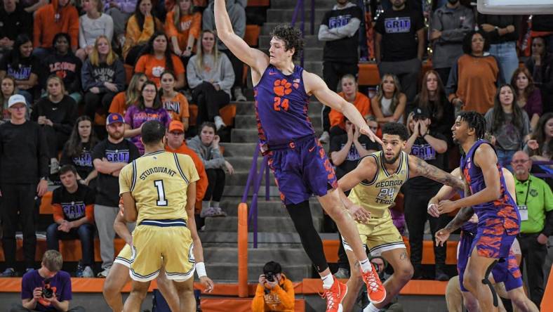 Jan 24, 2023; Clemson, South Carolina, USA; Clemson Tigers center PJ Hall (24) defends against Georgia Tech Yellow Jackets guard Kyle Sturdivant (1) during the second half at Littlejohn Coliseum. Mandatory Credit: Ken Ruinard-USA TODAY Sports