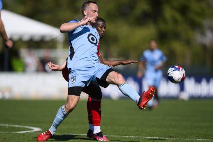 Feb 11, 2023; Indio, CA, USA; Minnesota United Brent Kallman (14) kicks the ball away from New York Red Bulls Elias Manoel (11) at Empire Polo Club. Mandatory Credit: Kelvin Kuo-USA TODAY Sports