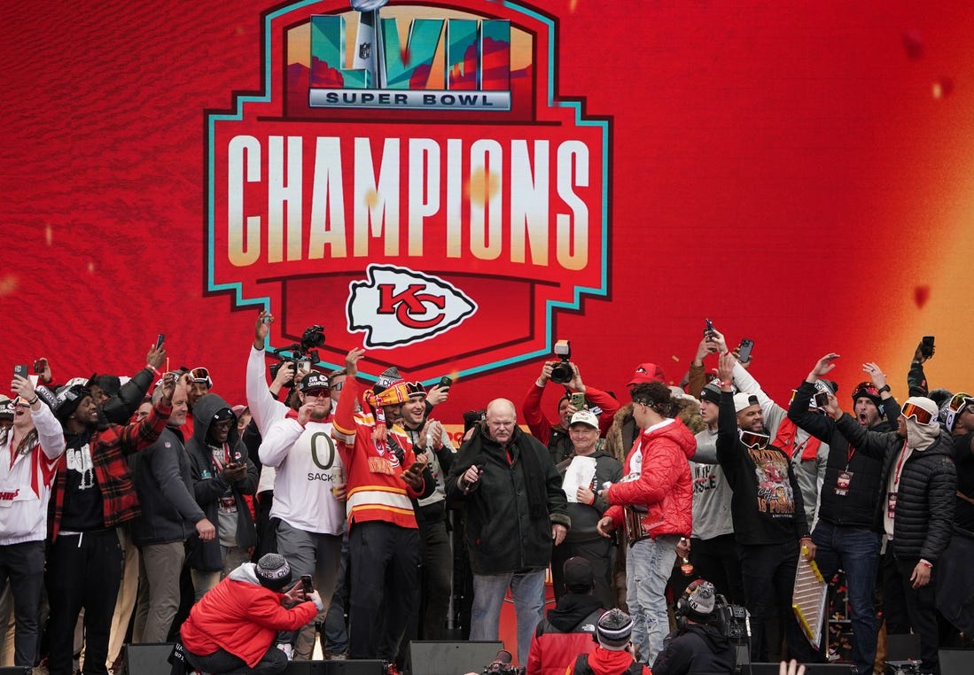 Kansas City Chiefs head coach Andy Reid celebrates with quarterback Patrick Mahomes (15) and other players in 2023 during the Kansas City Chiefs Super Bowl parade. Mandatory Credit: Denny Medley-USA TODAY Sports