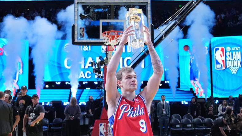 Feb 18, 2023; Salt Lake City, UT, USA; Philadelphia 76ers guard Mac McClung (9) celebrates with the trophy after winning the Dunk Contest during the 2023 All Star Saturday Night at Vivint Arena. Mandatory Credit: Kyle Terada-USA TODAY Sports