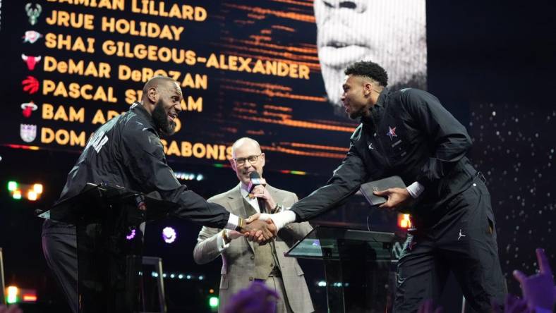 Feb 19, 2023; Salt Lake City, UT, USA; Team LeBron forward LeBron James (left) shakes hands with Team Giannis forward Giannis Antetokounmpo (right) after completing the draft before the 2023 NBA All-Star Game at Vivint Arena. Mandatory Credit: Kyle Terada-USA TODAY Sports