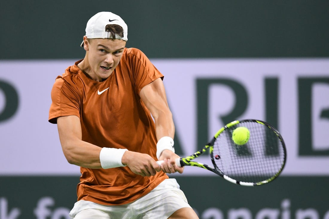 Mar 11, 2023; Indian Wells, CA, USA; Holger Rune (DEN) hits a backhand during his second round match against Mackenzie McDonald (USA) during the BNP Paribas Open at Indian Wells Tennis Garden. Mandatory Credit: Jonathan Hui-USA TODAY Sports