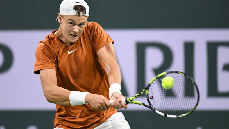 Mar 11, 2023; Indian Wells, CA, USA; Holger Rune (DEN) hits a backhand during his second round match against Mackenzie McDonald (USA) during the BNP Paribas Open at Indian Wells Tennis Garden. Mandatory Credit: Jonathan Hui-USA TODAY Sports