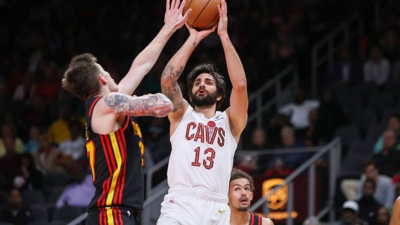 Mar 28, 2023; Atlanta, Georgia, USA; Cleveland Cavaliers guard Ricky Rubio (13) shoots over Atlanta Hawks guard Vit Krejci (27) in the second quarter at State Farm Arena. Mandatory Credit: Brett Davis-USA TODAY Sports