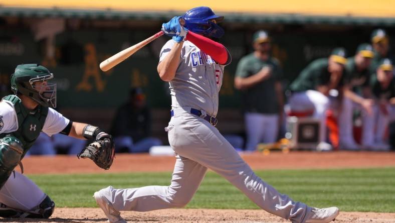 Apr 19, 2023; Oakland, California, USA; Chicago Cubs first baseman Eric Hosmer (51) hits a home run against the Oakland Athletics during the eighth inning at Oakland-Alameda County Coliseum. Mandatory Credit: Darren Yamashita-USA TODAY Sports