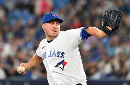 Jun 23, 2023; Toronto, Ontario, CAN;   Toronto Blue Jays relief pitcher Erik Swanson (50) delivers a pitch against the Oakland Athletics in the eighth inning at Rogers Centre. Mandatory Credit: Dan Hamilton-USA TODAY Sports