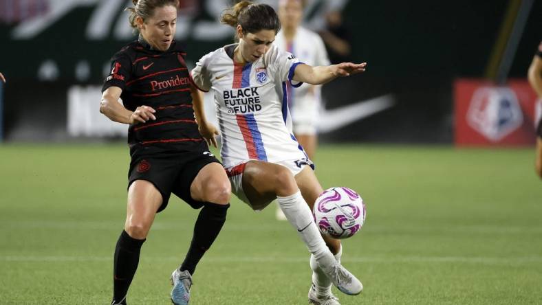 Jun 28, 2023; Portland, OR, USA; OL Reign forward McKenzie Weinert (51) kicks the ball past the Portland Throws FC during the second half at Providence Park. Mandatory Credit: Soobum Im-USA TODAY Sports