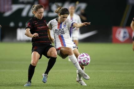 Jun 28, 2023; Portland, OR, USA; OL Reign forward McKenzie Weinert (51) kicks the ball past the Portland Throws FC during the second half at Providence Park. Mandatory Credit: Soobum Im-USA TODAY Sports