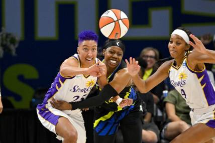 Jul 22, 2023; Arlington, Texas, USA; Los Angeles Sparks guard Layshia Clarendon (25) and guard Lexie Brown (4) and Dallas Wings guard Arike Ogunbowale (24) battle for the loose ball during the second half at College Park Center. Mandatory Credit: Jerome Miron-USA TODAY Sports