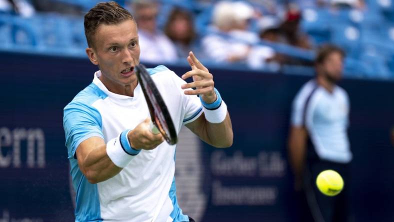 Aug 15, 2023; Mason, OH, USA; Jiri Lehecka, of Czech Republic, hits a return to Taylor Fritz, of the United States, during the Western & Southern Open at Lindner Family Tennis Center. Mandatory Credit: Albert Cesare-USA TODAY Sports