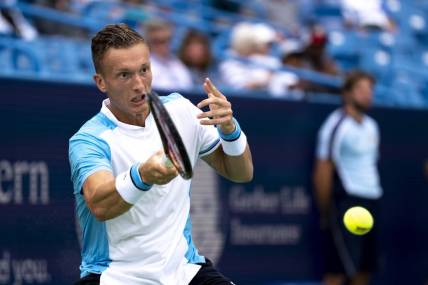 Aug 15, 2023; Mason, OH, USA; Jiri Lehecka, of Czech Republic, hits a return to Taylor Fritz, of the United States, during the Western & Southern Open at Lindner Family Tennis Center. Mandatory Credit: Albert Cesare-USA TODAY Sports