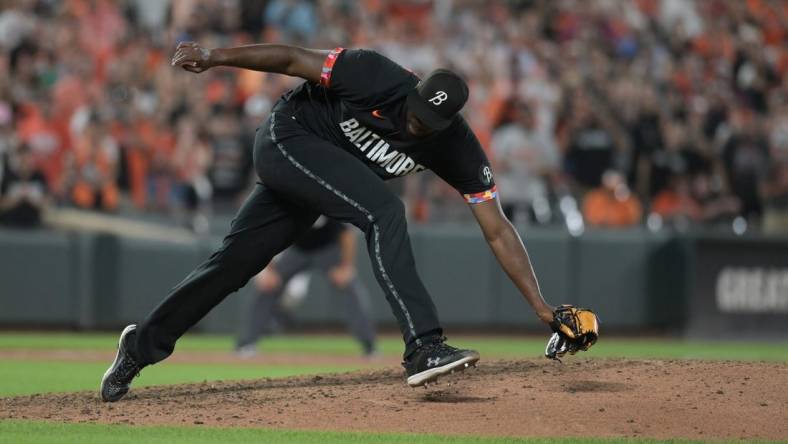 Aug 25, 2023; Baltimore, Maryland, USA; Baltimore Orioles relief pitcher Felix Bautista (74) slips while throwing a ninth inning pitch against the Colorado Rockies  at Oriole Park at Camden Yards. Mandatory Credit: Tommy Gilligan-USA TODAY Sports