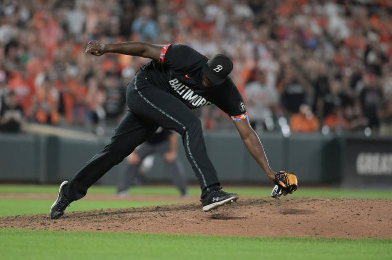 Aug 25, 2023; Baltimore, Maryland, USA; Baltimore Orioles relief pitcher Felix Bautista (74) slips while throwing a ninth inning pitch against the Colorado Rockies  at Oriole Park at Camden Yards. Mandatory Credit: Tommy Gilligan-USA TODAY Sports