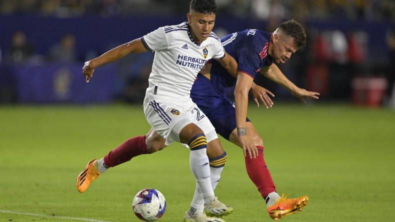 Aug 26, 2023; Carson, California, USA;  Los Angeles Galaxy midfielder Memo Rodriguez (20) and Chicago Fire midfielder Gaston Gimenez (30) battle for the ball in the first half at Dignity Health Sports Park. Mandatory Credit: Jayne Kamin-Oncea-USA TODAY Sports