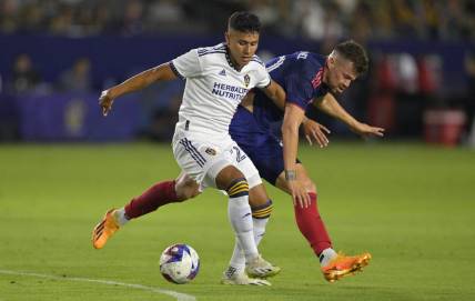 Aug 26, 2023; Carson, California, USA;  Los Angeles Galaxy midfielder Memo Rodriguez (20) and Chicago Fire midfielder Gaston Gimenez (30) battle for the ball in the first half at Dignity Health Sports Park. Mandatory Credit: Jayne Kamin-Oncea-USA TODAY Sports
